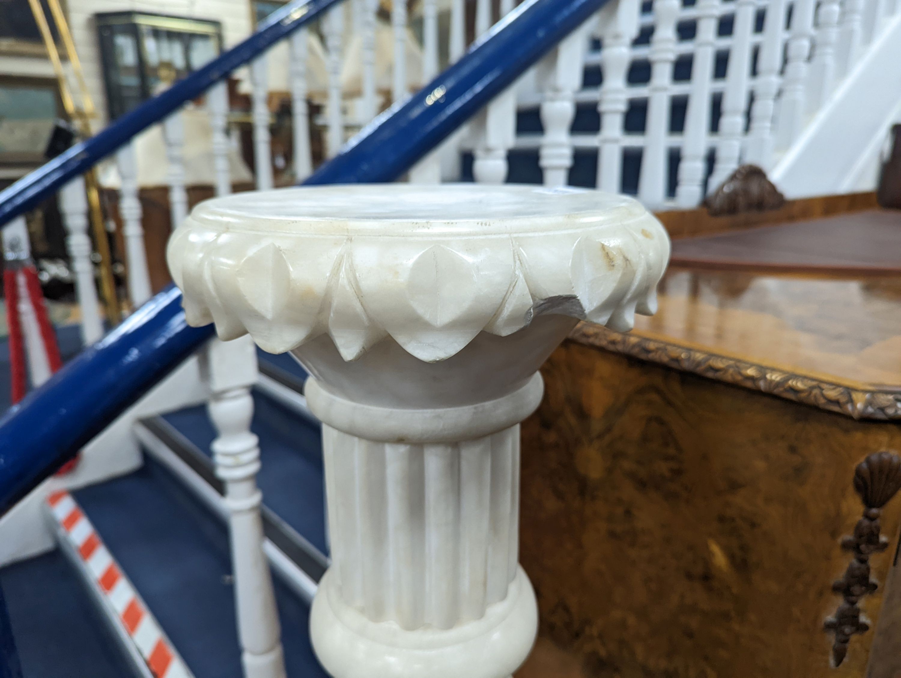 A carved alabaster pedestal on octagonal base, height 108cm